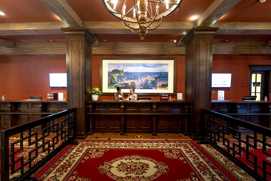 Elegant and luxurious hotel reception with classic wooden design and plush carpeting.